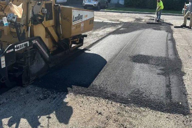 Asphalt paving machine laying new asphalt